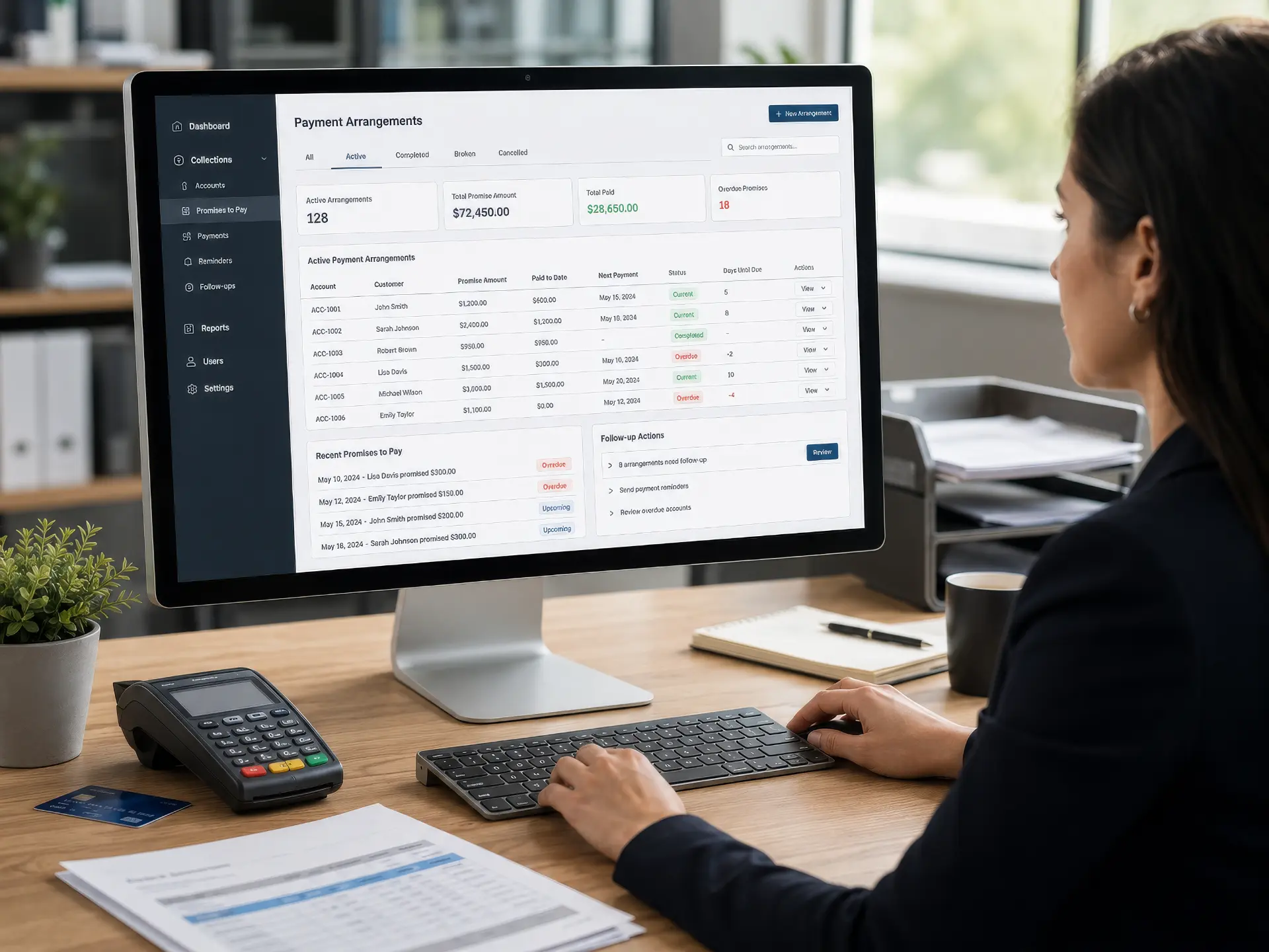 Professional reviewing the Debtcol Pro Payment Arrangements dashboard on a desktop monitor